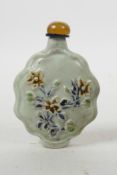 A Chinese Sancai porcelain snuff bottle with floral decoration, 4" high