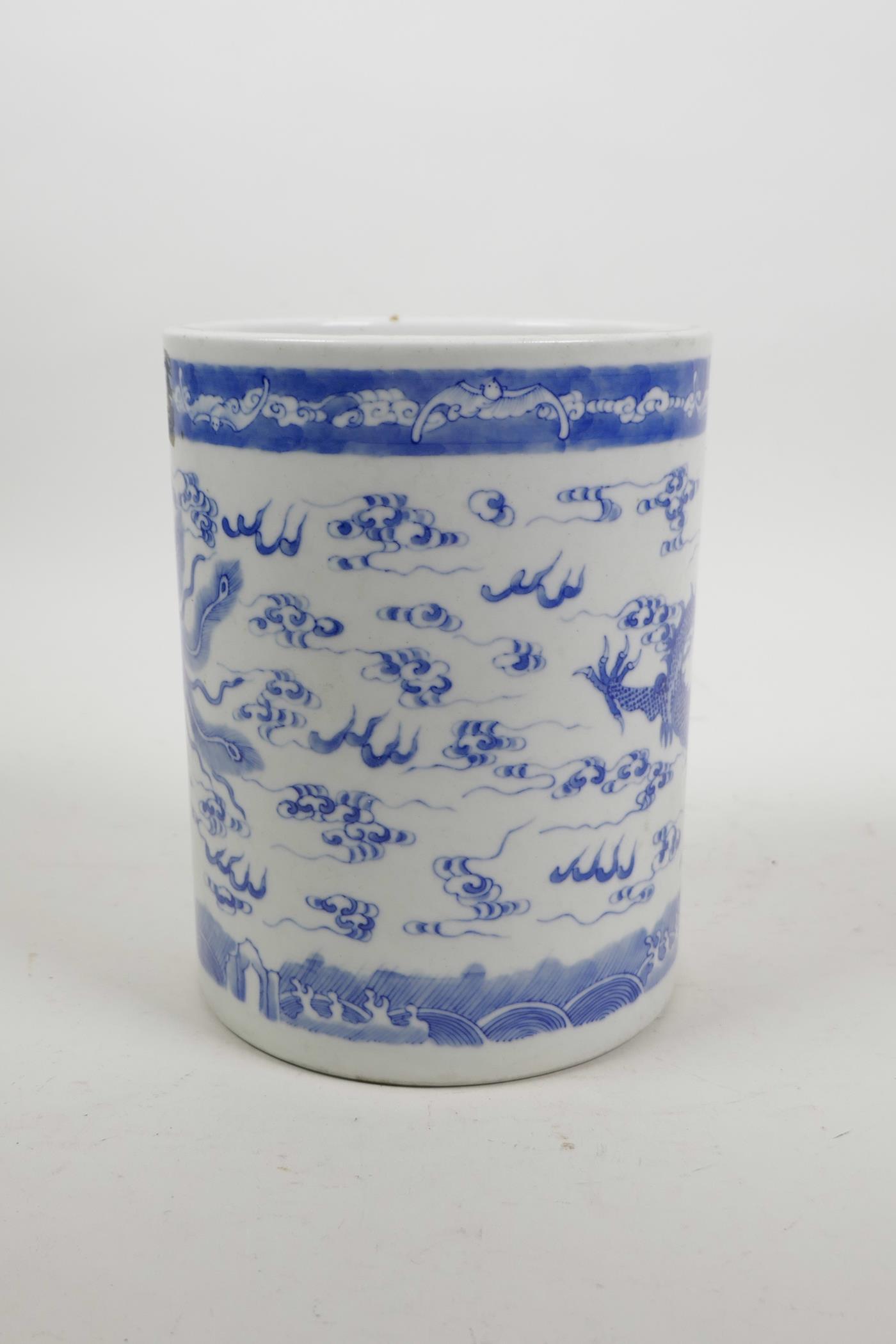 A Chinese blue and white porcelain brush pot decorated with a dragon and phoenix chasing the flaming - Image 4 of 5