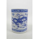 A Chinese blue and white porcelain brush pot decorated with a dragon and phoenix chasing the flaming