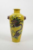 A Chinese Sancai pottery vase with two lion mask handles and dragon decoration, 6 character mark