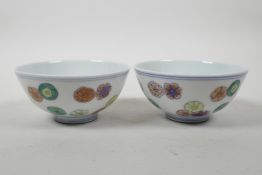 A pair of Chinese doucai porcelain rice bowls with floral decoration, 6 character mark to base,