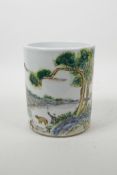 A Chinese famille verte porcelain brush pot decorated with a figure and animals in a landscape,