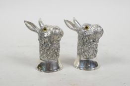 A pair of silver plated condiments in the form of hares, 2½"