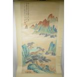 A Chinese watercolour scroll depicting a solitary figure in a mountain landscape, 19½" x 39"
