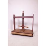 A vintage walnut book press marked NGSL maker and numbered 16674, 24" high, 24½" wide