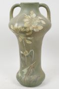 A decorative Satsuma porcelain vase with two handles, decorated with stylised flowers on a pale