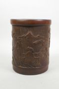 A Chinese carved bamboo brush pot decorated with figures in a landscape, 6½" high, 5½" diameter