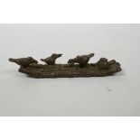 An Oriental bronzed metal incense stick holder in the form of a raft with birds, 4" long