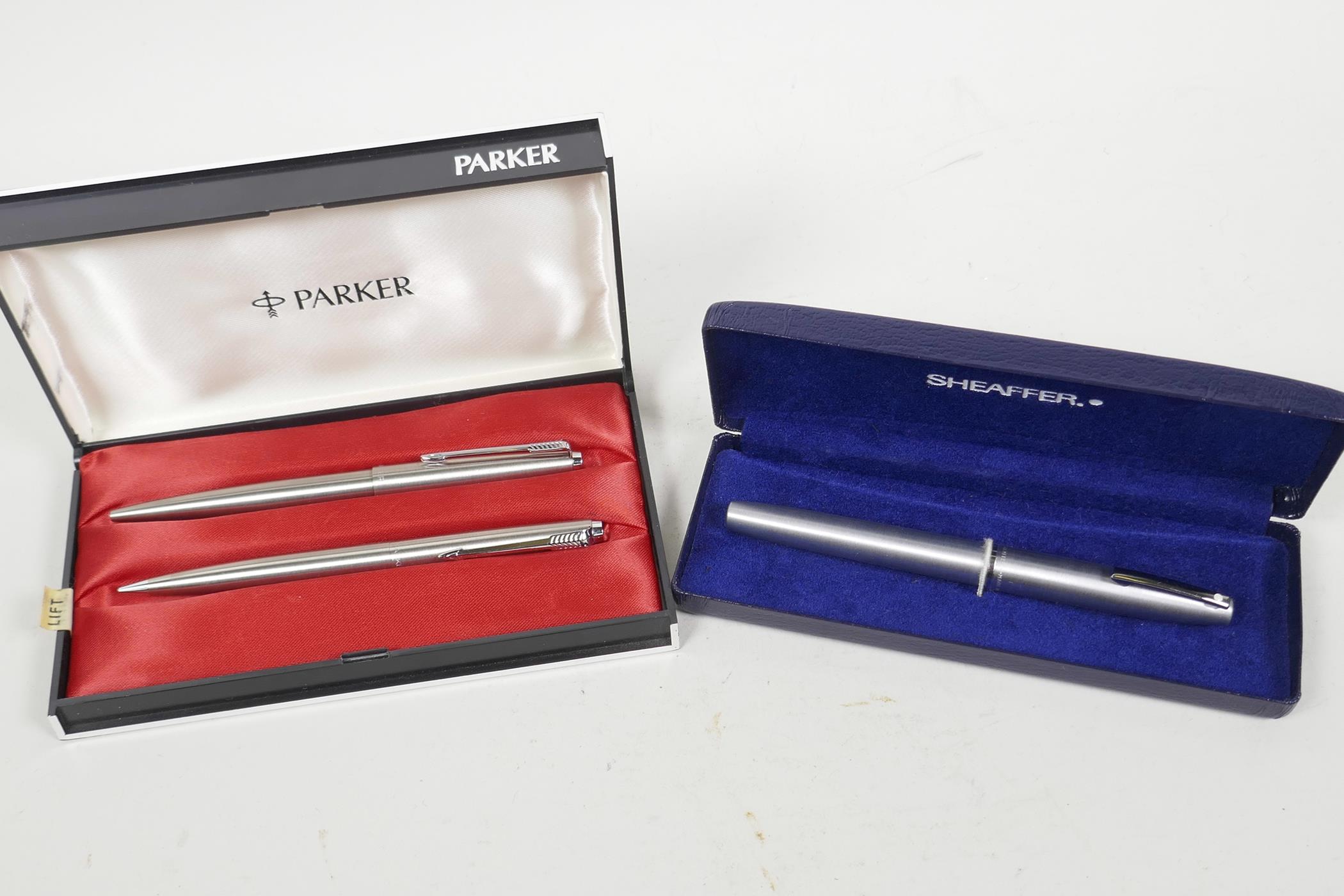 A Sheaffer fountain pen together with a Parker ball point pen and pencil set