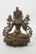 A Sino-Tibetan bronze of a female deity with distressed gilt patina, 8" high