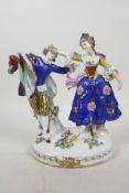 A C19th Chelsea style porcelain figure of an C18th courting couple, brightly hand painted in