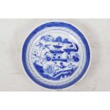 A small Chinese blue and white porcelain dish decorated with pagodas and trees by a lake