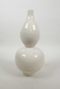 A Chinese cream ground porcelain double gourd vase with incised floral decoration, 11" high