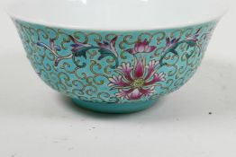 A Chinese porcelain rice bowl painted with bats and flowers on a turquoise ground, 5¼" diameter