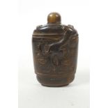 A Chinese horn snuff bottle with carved kylin decoration, 3½" high