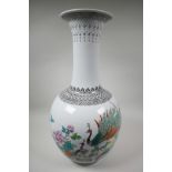 A Chinese famille rose porcelain floor vase, mid C20th, painted with a pair of peacocks, peony