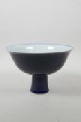 A Chinese powder blue glazed porcelain stem bowl with underglaze dragon decoration, 6 character mark