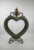 A coppered and pierced metal heart shaped lantern, 20" x 14"