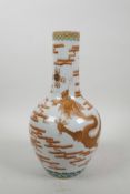 A Chinese polychrome porcelain vase decorated with an iron red dragon chasing a gilt flaming