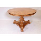 A C19th Biedermeier style tilt top satinwood breakfast table, raised on a hexagonal column with