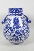 A Chinese blue and white porcelain vase of bulbous form with two deer head handles, decorated with