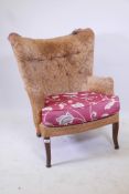 A mid century Strongbow wing back armchair, with tub shaped back