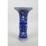 A Chinese blue and white porcelain Gu shaped vase with child and lotus flower decoration, 9" high