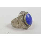 A medieval style white metal ring set with a reconstituted blue stone