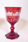 A Bohemian ruby overlaid glass goblet, engraved with eight vignettes of towns on the Rhine with