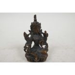 A Sino-Tibetan figure of a deity, double vajra mark to base, 3¼" tall