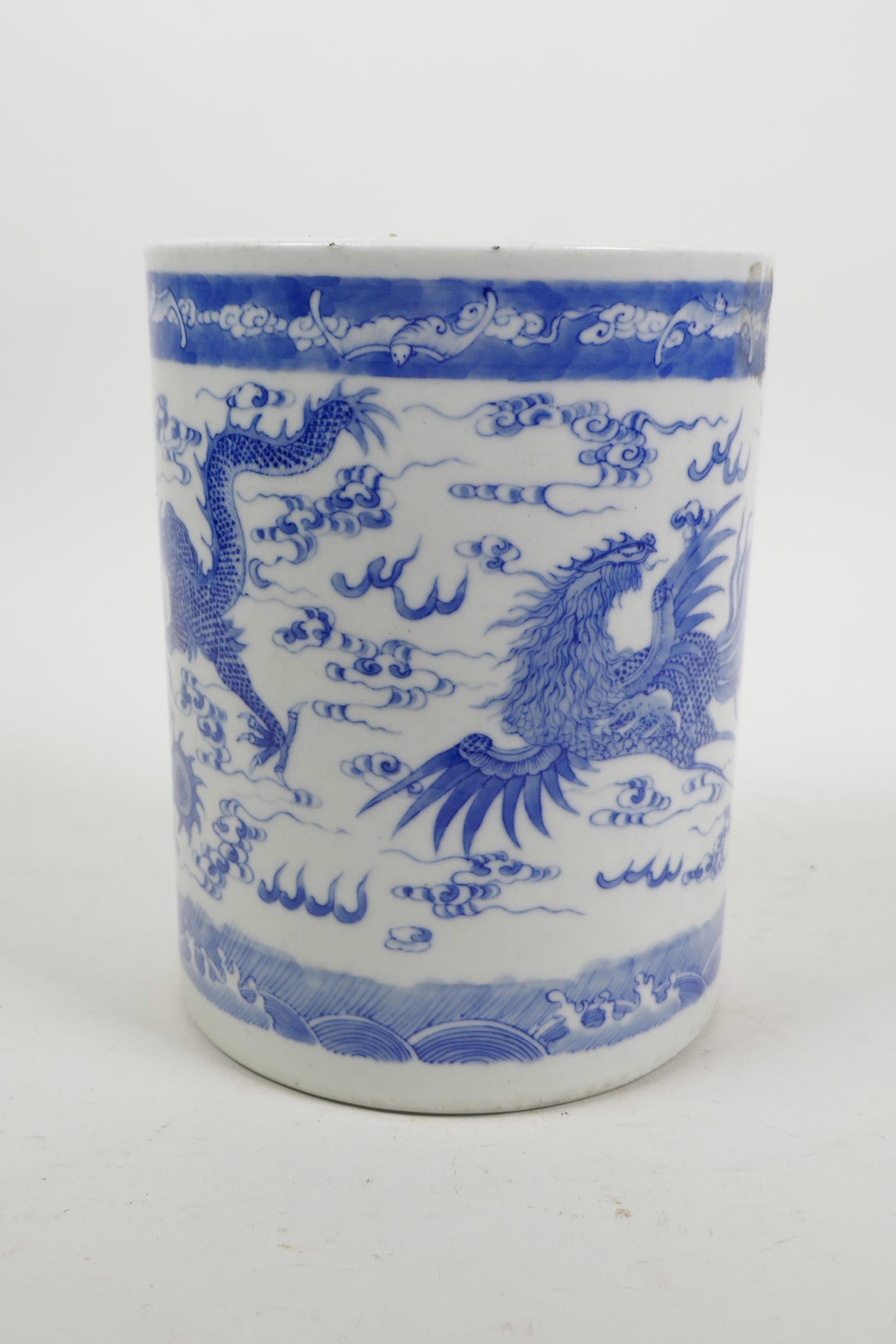 A Chinese blue and white porcelain brush pot decorated with a dragon and phoenix chasing the flaming - Image 2 of 5