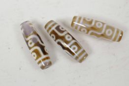 Three Tibetan agate dzi beads, 2" long