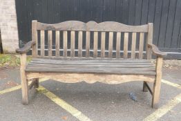 A teak garden bench by P.J. Bridgman & Co, 63½" long