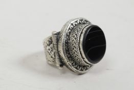 A Roman style white metal ring set with a black banded agate stone