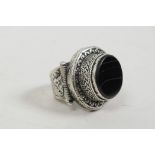 A Roman style white metal ring set with a black banded agate stone