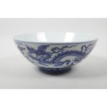 A Chinese blue and white porcelain bowl decorated with two dragons, 6 character mark to lip, 9"