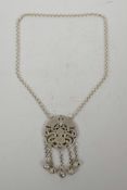 A Chinese white metal pendant necklace with pierced bat and dragon decoration, 24" long