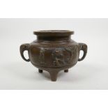 A Chinese bronze censer on tripod feet with elephant mask handles, impressed 4 character mark to
