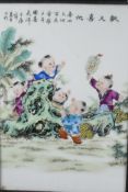 A Chinese carved hardwood table screen with porcelain panel decorated with boys at play, 27" high,
