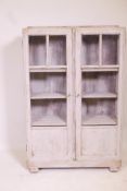 An Art Deco oak two door display cabinet with distressed painted finish, 28" x 8" x 42"