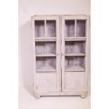 An Art Deco oak two door display cabinet with distressed painted finish, 28" x 8" x 42"