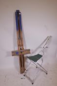 An artist's folding easel, 62" high, and a portable aluminium easel with seat