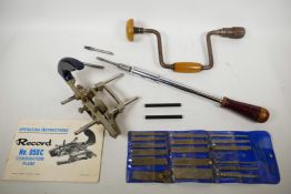 A Yankee Pump screwdriver, Stanley No.131A, and three screw heads, a Record Combination Plane, No.