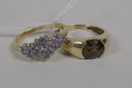 A 9ct gold ring set with a tanzanite stone, and a 9ct gold ring set with blue stones, 6.9 grams