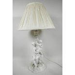 A Parian ware porcelain table lamp in the form of a mother and child on a flower encrusted base, 14"