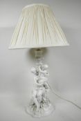 A Parian ware porcelain table lamp in the form of a mother and child on a flower encrusted base, 14"