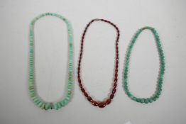Two green hardstone graduated bead necklaces and another faceted and graduated bead necklace, 22"