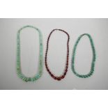 Two green hardstone graduated bead necklaces and another faceted and graduated bead necklace, 22"