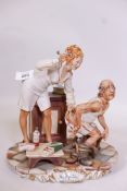 A Capodimonte figure group by Enzo Arzenton depicting a nurse and old man, 10" high