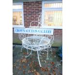 A white painted metal garden table and four chairs, the table with a glass top, 36" diameter, 30½"